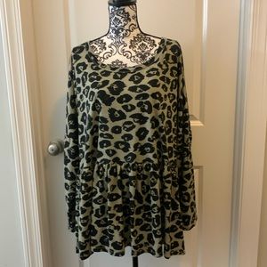 Woman’s long sleeve animal print babydoll top with rounded neckline.